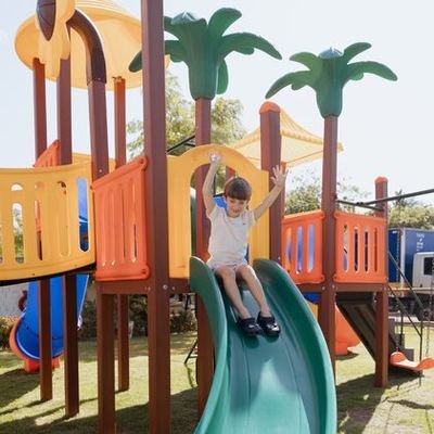 Criança no escorregador do playground Tointoin